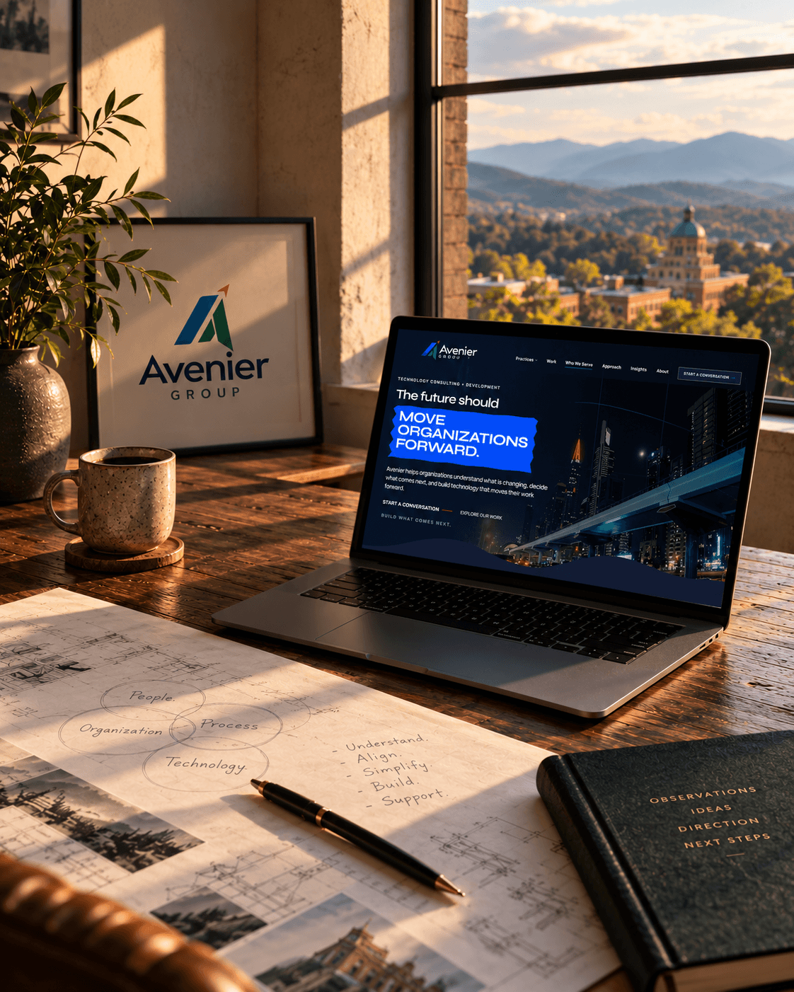 Editorial representation of an Avenier workspace with the Avenier website on a laptop, planning documents, and Blue Ridge mountains beyond the window.